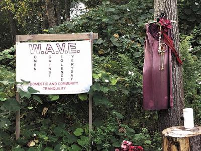 A red dress, a symbol of the plight of missing and murdered indigenous women and organized efforts to fight Native American women’s heightened risk of violence, hangs near the Peace Fire site on the Shinnecock Reservation in Southampton.