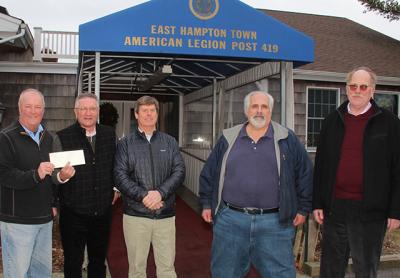 Bill Mott, commander of the East Hampton American Legion Post, left, accepted a $5,400 check Monday from John McGuirk of Dayton, Ritz and Osborne Insurance for a 9/11 memorial to be built at the legion property in Amagansett. Also pictured are Fred Ritz, Tony Ganga of the Sons of the American Legion, and George Yates, also of the insurance firm.