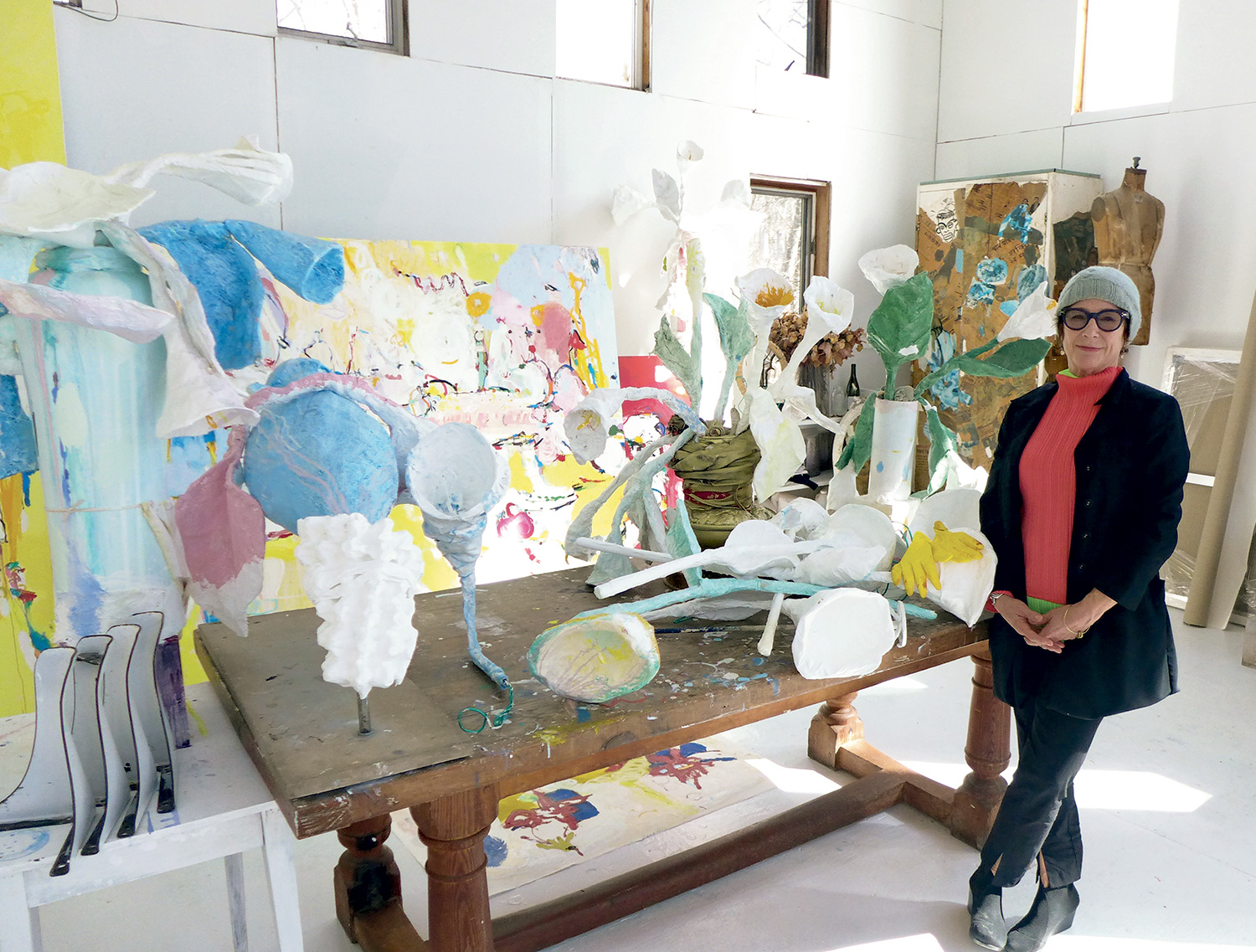 Priscilla Heine was surrounded in her studio by elaborate calla lily-inspired sculptures and large, vividly colored paintings.