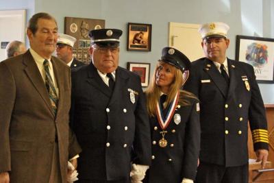 Karen Haab  received the EMS Provider of the Year Award from the Firemen’s Association of the State of New York on Saturday for helping save the life of Stuart Herman, left. Joining them were Lt. James Gledhill, who nominated Ms. Haab for the award, and Springs Fire Chief Ben Miller.