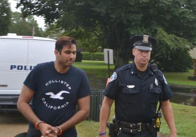 Krishna L. Parihar, who is accused of impersonating a New York City police officer, was led into East Hampton Town Justice Court back in September. Krishna L. Parihar, who is accused of impersonating a New York City police officer, was led into East Hampton Town Justice Court back in September.