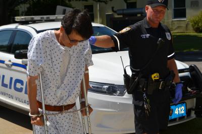 Jungsik Lee used crutches to walk into East Hampton Town Justice Court where he faces a driving while intoxicated charge on Tuesday.