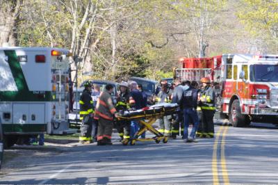 Firefighters and emergency medical workers set up at a house fire. Firefighters and emergency medical workers set up at a house fire.