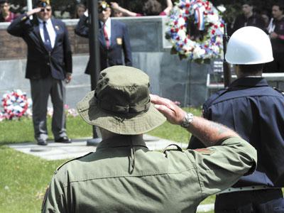 Fred Overton, rear left, commander of East Hampton American Legion Post 419, saluted fellow veterans at the Hook Mill green on Monday. Fred Overton, rear left, commander of East Hampton American Legion Post 419, saluted fellow veterans at the Hook Mill green on Monday.