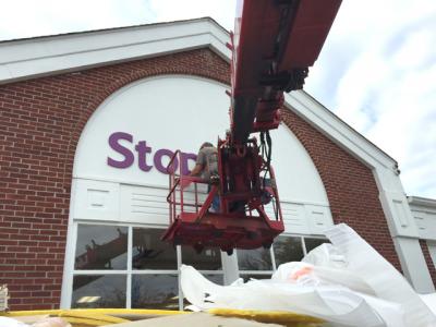 In with the new: A worker hung the new Stop and Shop sign on the former Waldbaum's store on Oct. 9. In with the new: A worker hung the new Stop and Shop sign on the former Waldbaum's store on Oct. 9.