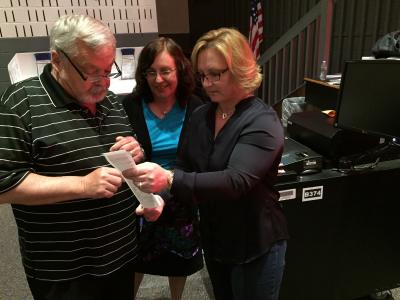 In East Hampton, the ballot counting began just after 8 p.m. From left, John Bouvier and Laura Oliverio, both election inspectors, reviewed an election receipt with Kerri Stevens, the district clerk.