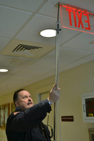 A dead battery in a Town Justice Court exit sign drew the attention of Tom Baker, a town fire marshal, on Friday. A dead battery in a Town Justice Court exit sign drew the attention of Tom Baker, a town fire marshal, on Friday.
