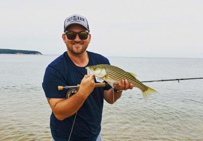 While fly-casting from shore, Harris Stoker landed and released this small striped bass off Navy Beach. While fly-casting from shore, Harris Stoker landed and released this small striped bass off Navy Beach.