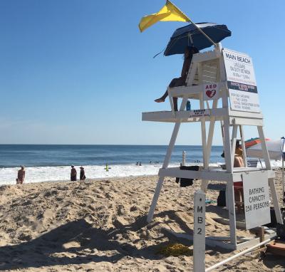 Lifeguards kept watch on the ocean at Main Beach in East Hampton on Wednesday afternoon, where they were flying a yellow flag, not because of the shark bites in the water off Fire Island, but because of rough conditions. Lifeguards kept watch on the ocean at Main Beach in East Hampton on Wednesday afternoon, where they were flying a yellow flag, not because of the shark bites in the water off Fire Island, but because of rough conditions.