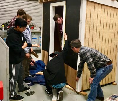 Andrew Rigby, right, the technology and manufacturing teacher at East Hampton High School, gave a lesson on shingling the exterior of a building, as part of a building trades class. Andrew Rigby, right, the technology and manufacturing teacher at East Hampton High School, gave a lesson on shingling the exterior of a building, as part of a building trades class.
