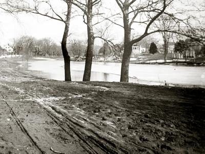 Main Street, East Hampton, in the days of horse and buggy, with the South End Burying Ground visible on the other side of a frozen Town Pond