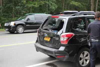 A utility truck rear-ended a Subaru Forester, which then hit the back of a school bus. No children were on board the bus. A utility truck rear-ended a Subaru Forester, which then hit the back of a school bus. No children were on board the bus.