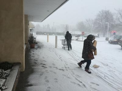 Last customers carefully traversed the snow outside the Amagansett I.G.A. before it closed at 9:45 a.m.