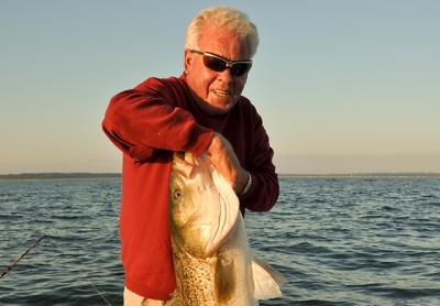 Capt. John Rade, seen here with a massive striped bass, will be honored as the Fishing Legend of the Year at the conclusion of the Montauk Mercury Grand Slam Fishing Tournament on Sunday.