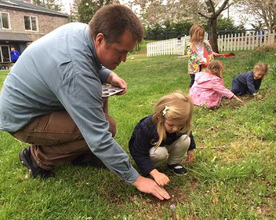 Bryan Smith, one of the Ross Lower School’s science teachers, helped a student plant a seedling on Tuesday morning before the rain set in.