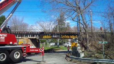 A crane with a boom approximately 80 feet long was brought in to make repairs to the train trestle after it was struck on Monday morning. A crane with a boom approximately 80 feet long was brought in to make repairs to the train trestle after it was struck on Monday morning.