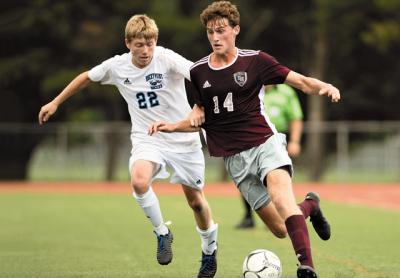 A goal by Zane Musnicki, at right, shown in earlier-season action, earned East Hampton a playoff berth at Wyandanch Friday.