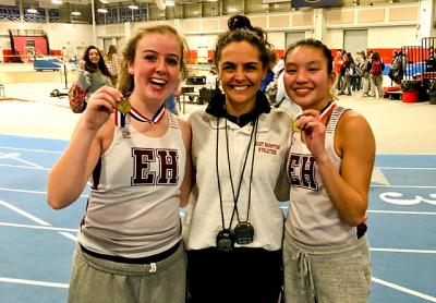 Mimi Fowkes, left, and JiJi Kramer celebrated their Zeitler Relay racewalk win with their coach, Yani Cuesta, afterward.