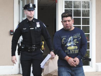 Gerson Mancilla, shown here being led away from East Hampton Town Justice Court on Sunday after being arraigned on a felony driving while intoxicated charge, was able to obtain a taxi driver’s license from the town earlier this year, despite a previous felony conviction. Gerson Mancilla, shown here being led away from East Hampton Town Justice Court on Sunday after being arraigned on a felony driving while intoxicated charge, was able to obtain a taxi driver’s license from the town earlier this year, despite a previous felony conviction.