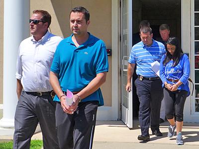 Melih and Asli Dincer were escorted from court on Friday after being arraigned on charges stemming from alleged threats made against the Jewish Center of the Hamptons.