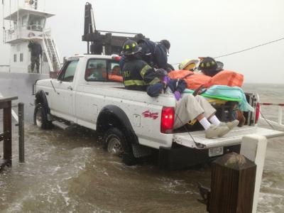Emergency volunteers shielded a 92-year-old woman as she was taken onto a Shelter Island ferry Monday afternoon. Emergency volunteers shielded a 92-year-old woman as she was taken onto a Shelter Island ferry Monday afternoon.