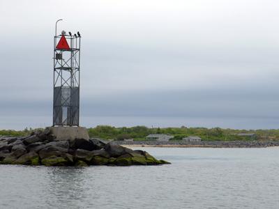 Montauk's inlet jetty with the narrow Soundview Drive beach in the background Montauk's inlet jetty with the narrow Soundview Drive beach in the background