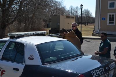 Joseph R. Spezzano ducks his head as he gets into a Suffolk County Deputy Sheriff's vehicle for the county jail, where he will spend the next six months. Joseph R. Spezzano ducks his head as he gets into a Suffolk County Deputy Sheriff's vehicle for the county jail, where he will spend the next six months.