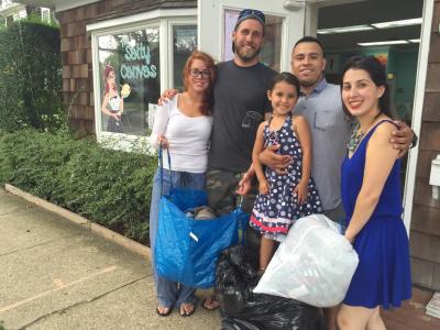 Kathryn Bermudez, right, and Nikki Payne, left, are collecting gently used clothing to distribute to needy kids. Ms. Bermudez and Ms. Payne are pictured from left with John Holden, Ms. Payne's fiancé; Nicole Rodriguez, Ms. Bermudez's daughter, and Francis Rodriguez, Ms. Bermudez's husband, outside The Salty Canvas on Newtown Lane.