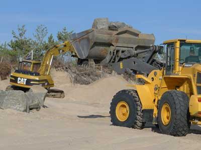 Workers placed boulders in front of a Georgica Beach property Wednesday while a lawyer for the East Hampton Town Trustees sought a court injunction to stop them. Workers placed boulders in front of a Georgica Beach property Wednesday while a lawyer for the East Hampton Town Trustees sought a court injunction to stop them.
