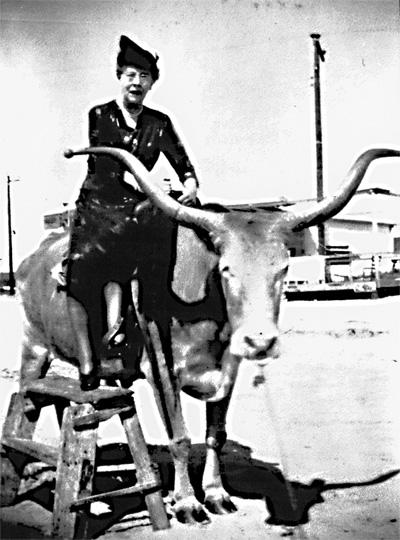 Bertha Edwards, principal of the Springs School for one year and a teacher for many more, on a fake bull at a fair in Riverhead circa 1930.