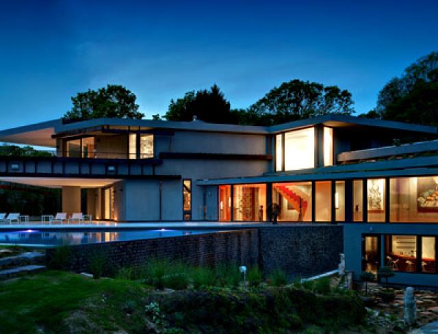 A sunken courtyard off the lower level and cantilevered overhangs off the library and master bedroom, add outdoor living space.