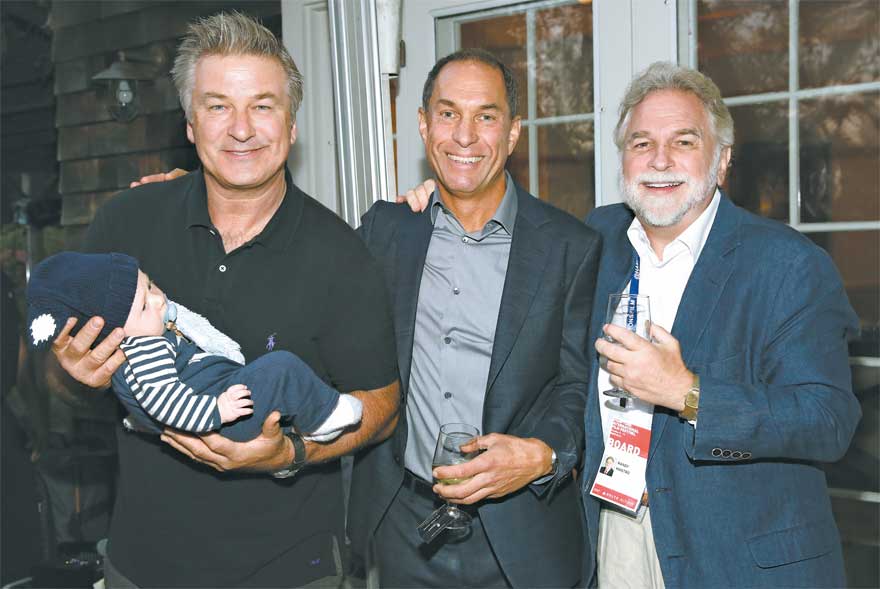 Alec Baldwin, holding his son Rafael, at last year’s Hamptons International Film Festival with Stuart Match Suna and Randy Mastro, right. It was during last year’s festival that Mr. Baldwin and Mr. Mastro became co-chairmen after Mr. Suna’s retirement.