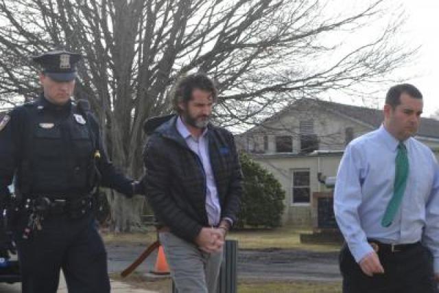 East Hampton Village Police Officer Jack Bartelme led Kyle Lynch into East Hampton Town Justice Court on Wednesday morning, accompanied by Detective Steven Sheades.