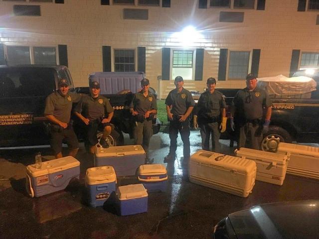 D.E.C. officers dockside in Montauk after seizing what they said were about 1,800 undersized fish left by anglers who had been aboard the Viking Starship party boat on Sept. 16.