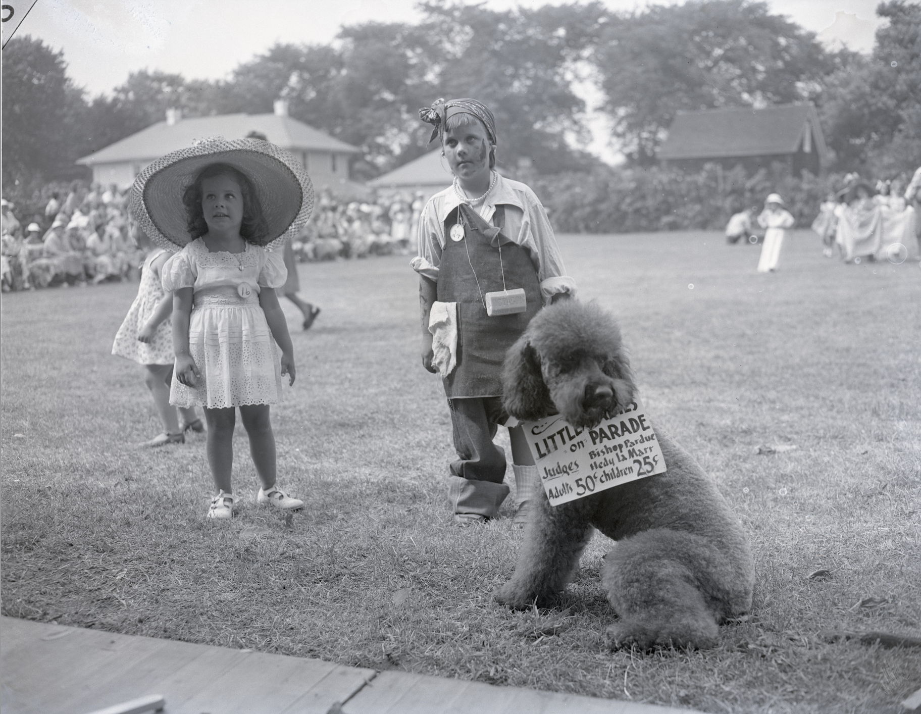 Little girls at the L.V.I.S. Fair in a dress-up-like-a-lady contest, judged by the actress Hedy Lamarr and a prominent Episcopal clergyman, Bishop Austin Pardue, 1950. East Hampton Star archive
