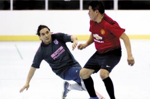 Eddy Sacaquirin, right, of Liga del Milagro headed a ball while Hugo Villacis of the East Hampton Soccer Stars applied defensive pressure in recent over-37 league action at the Sportime Arena in Amagansett.