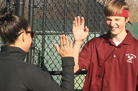Jordan Foster, whose net play earned the second doubles team the pivotal point in the match with Westhampton Beach, was greeted as he came off the court with a high-five from his coach, Katie Helfand.