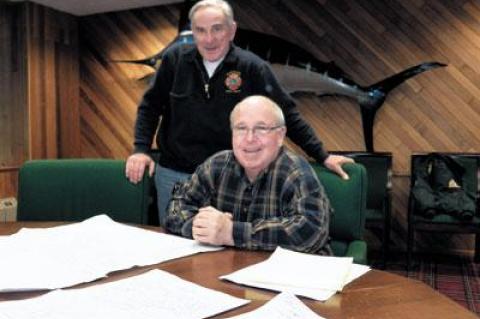 Montauk Fire Chief Rich Schoen, standing, looked at maps that Peter Joyce, a fireman and former chief, has identified as being among the most vulnerable to damage should a storm like Hurricane Sandy hit Montauk.