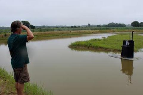 Randy Parsons, who keeps a close eye on East Hampton farmland from his office at the Nature Conservancy, saluted the simulated submarine conning tower that has floated in a drainage basin off Route 114 since the spring.