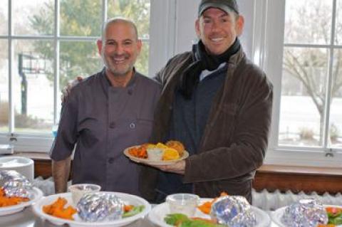 Daniel Pacella, the chef for the Bridgehampton School, left, and Sean Barrett, the founder of Dock to Dish, celebrated the road test of the school’s new fish burger lunch.