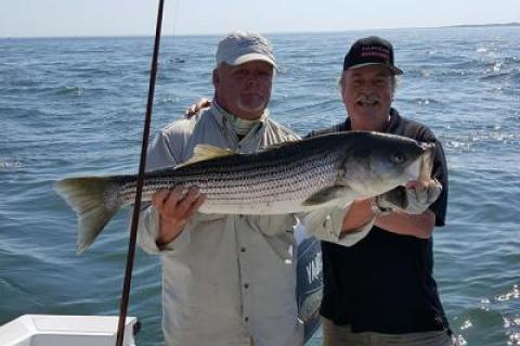 Peter Honerkamp, right, fishing with Capt. Ken Rafferty in Gardiner’s Bay, caught a 30-pound striped bass, his first.