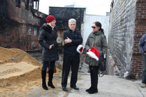 On Dec. 21, Suffolk County Legislator Bridget Fleming, County Executive Steve Bellone, and Sag Harbor Village Mayor Sandra Schroeder stopped at the site of the demolished buildings during an outing to encourage people to shop locally after the fire.