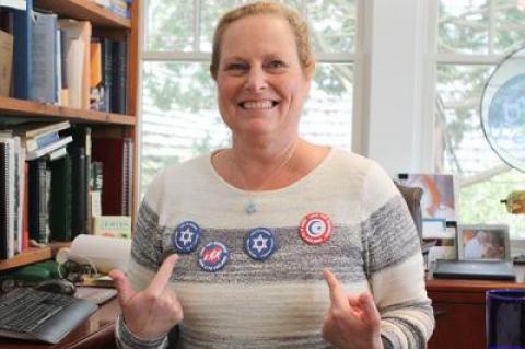 Cantor Debra Stein is among the members of East Hampton Clericus distributing buttons bearing the message “Love Thy Neighbor.”