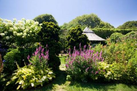 At East Hampton’s legendary Grey Gardens, a “fairy cottage” beckons through a break in the plantings.
