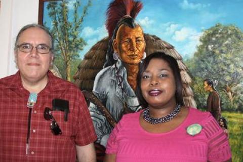 A painting by David Bunn Martine, left, a Shinnecock artist, served as a colorful backdrop for a photo with Georgette Grier-Key, director of the Eastville Community Historical Society, at the opening of the society’s new exhibit, “Native American Life on the East End.” A painting by David Bunn Martine, left, a Shinnecock artist, served as a colorful backdrop for a photo with Georgette Grier-Key, director of the Eastville Community Historical Society, at the opening of the society’s new exhibit, “Native American Life on the East End.”