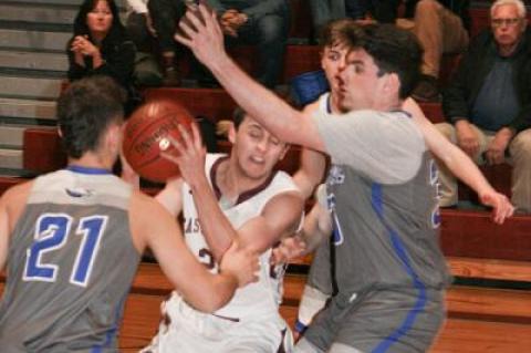 Bonac’s Jack Reese fought through traffic in the early going of the Jan. 31 boys basketball game here with Hauppauge. Even though he sat for most of the fourth quarter, the versatile senior point guard finished with 23 points in the 76-55 win.