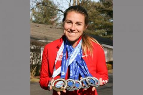 Cara Nelson sports her seven marathon medals won in seven days on seven continents.
