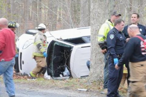 Emergency crews worked to free the occupant of a vehicle that rolled over onto its side in the woods off Accabonac Road in Amagansett on Tuesday afternoon.