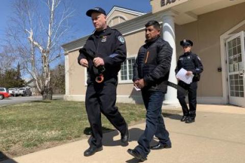 East Hampton Town police led Juan M. Bacuilima out of East Hampton Town Justice Court on Thursday morning after his arraignment. East Hampton Town police led Juan M. Bacuilima out of East Hampton Town Justice Court on Thursday morning after his arraignment.