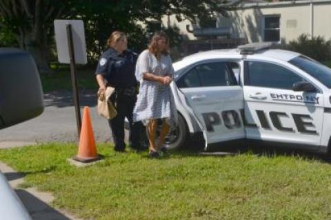 Julia Moffett was led into East Hampton Town Justice Court for her arraignment on Thursday. Her lawyers said "there is no evidence that my client has done anything wrong."